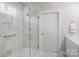 A modern bathroom with marble tile and a sleek glass-enclosed shower at 3848 Zemosa Nw Ln, Concord, NC 28027