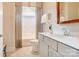 Well-lit bathroom with a single vanity, framed mirror, tiled floors, and a shower with a shower curtain at 3848 Zemosa Nw Ln, Concord, NC 28027