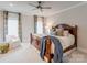 Bright bedroom featuring a wooden sleigh bed and a cozy armchair at 3848 Zemosa Nw Ln, Concord, NC 28027
