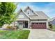 Charming home featuring a landscaped front yard, covered porch, and a two-car garage with beautiful detailing at 3848 Zemosa Nw Ln, Concord, NC 28027