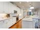Modern kitchen with white cabinets, stainless steel appliances, granite countertops, and a tiled backsplash at 3848 Zemosa Nw Ln, Concord, NC 28027