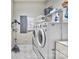 Well-organized laundry room with a modern washer, dryer, and plenty of shelving for storage at 3848 Zemosa Nw Ln, Concord, NC 28027