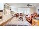 Cozy living room featuring a stylish rug, comfortable seating, built-in shelving, and hardwood flooring at 3848 Zemosa Nw Ln, Concord, NC 28027
