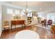 Bright living room featuring hardwood floors, built-in shelving, and plenty of natural light from large windows at 3848 Zemosa Nw Ln, Concord, NC 28027