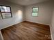 Well-lit bedroom with two windows and wood-look floors at 912 Surry Dr, Shelby, NC 28152
