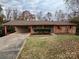 Brick ranch home with attached carport and landscaped yard at 912 Surry Dr, Shelby, NC 28152