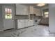 View of kitchen with ample counter space, white cabinets, and an exterior door at 912 Surry Dr, Shelby, NC 28152