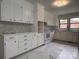 Bright kitchen featuring white cabinets, modern appliances, and marble tile floors at 912 Surry Dr, Shelby, NC 28152