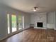 Open living space featuring hardwood floors and a fireplace leading to an outdoor balcony at 912 Surry Dr, Shelby, NC 28152