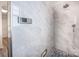 Modern bathroom featuring sleek gray tiles, rainfall shower head, and blue mosaic floor at 107 Monterey Dr, Mooresville, NC 28117