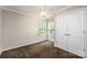 Inviting bedroom featuring carpet, ample natural light, and double door closet at 107 Monterey Dr, Mooresville, NC 28117