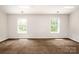 Bedroom featuring neutral carpet and natural light from two windows at 107 Monterey Dr, Mooresville, NC 28117