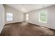 Bright bedroom featuring neutral carpet and multiple windows at 107 Monterey Dr, Mooresville, NC 28117