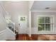 Bright entryway features hardwood floors, a staircase, and large windows at 107 Monterey Dr, Mooresville, NC 28117