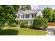 Charming two-story home with well-manicured lawn, mature trees, and classic shutters at 107 Monterey Dr, Mooresville, NC 28117