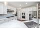 Elegant kitchen features white cabinets, stainless steel appliances and fixtures, with marble countertops at 107 Monterey Dr, Mooresville, NC 28117