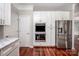 This kitchen shows white cabinets, stainless steel appliances, and hardwood floors at 107 Monterey Dr, Mooresville, NC 28117