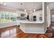 Bright kitchen featuring white cabinets, stainless steel appliances, marble countertops, and hardwood floors at 107 Monterey Dr, Mooresville, NC 28117
