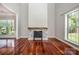 Spacious living room features a stone fireplace, hardwood floors, and large windows at 107 Monterey Dr, Mooresville, NC 28117