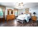 Comfortable bedroom with hardwood floors, ceiling fan, wooden furniture, and a decorative 'Home Sweet Home' pillow at 3092 Lee Lawing Rd, Lincolnton, NC 28092