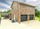 Back exterior featuring a brick wall and a covered patio with a table and chairs at 3092 Lee Lawing Rd, Lincolnton, NC 28092