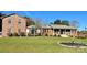 Charming brick home with well-maintained lawn, manicured landscaping and inviting front porch at 3092 Lee Lawing Rd, Lincolnton, NC 28092