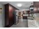 Modern kitchen boasts dark cabinets, granite countertops, stainless steel appliances, and ample storage at 3092 Lee Lawing Rd, Lincolnton, NC 28092