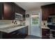 Well-lit kitchen featuring granite counters, dark cabinetry, and modern stainless steel appliances at 3092 Lee Lawing Rd, Lincolnton, NC 28092