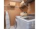 Functional laundry room with modern washer and dryer, shelving, and neutral walls at 3092 Lee Lawing Rd, Lincolnton, NC 28092