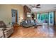 Cozy living room featuring brick fireplace, wood floors, large windows, and comfortable seating at 3092 Lee Lawing Rd, Lincolnton, NC 28092