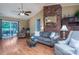 Comfortable living area showcasing a brick fireplace, wood flooring, and access to the outdoor patio at 3092 Lee Lawing Rd, Lincolnton, NC 28092