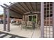 Covered patio features a dining table set, lounge chair, and string lights for outdoor living at 3092 Lee Lawing Rd, Lincolnton, NC 28092