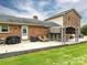 Brick patio with grill, lounge chairs, outdoor seating under a pergola, and manicured lawn at 3092 Lee Lawing Rd, Lincolnton, NC 28092