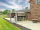 The patio has a table and chairs and is covered by a pergola-like structure that provides shade at 3092 Lee Lawing Rd, Lincolnton, NC 28092