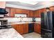 Well-equipped kitchen with modern appliances and wood cabinets at 4130 Charlotte Hwy # G, Lake Wylie, SC 29710