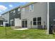 Home backyard featuring sliding glass door, small patio, and small fenced yard at 6259 Tea Olive Dr # 178, Harrisburg, NC 28075
