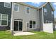 Back of the home featuring sliding glass door and small patio, small fenced yard, and exterior AC units at 6259 Tea Olive Dr # 178, Harrisburg, NC 28075