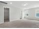 Spacious bedroom with neutral carpet, ample natural light, and a walk-in closet at 6259 Tea Olive Dr # 178, Harrisburg, NC 28075