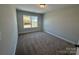 Bright bedroom featuring a window, neutral walls, and plush carpeting at 6259 Tea Olive Dr # 178, Harrisburg, NC 28075