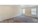 Bright bedroom with natural light and neutral carpet at 6259 Tea Olive Dr # 178, Harrisburg, NC 28075