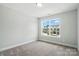 Bedroom with large window, neutral carpet, and light colored walls at 6259 Tea Olive Dr # 178, Harrisburg, NC 28075