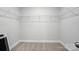 Bright walk-in closet featuring soft carpet and a white shelving and hanging system at 6259 Tea Olive Dr # 178, Harrisburg, NC 28075