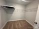 Walk-in closet with neutral carpet, light gray walls, wire shelving and an access hatch at 6259 Tea Olive Dr # 178, Harrisburg, NC 28075