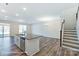 Kitchen with an island, stainless steel dishwasher and staircase in the background at 6259 Tea Olive Dr # 178, Harrisburg, NC 28075