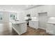 Modern kitchen with white cabinets, stainless steel appliances, island, and hardwood floors at 6259 Tea Olive Dr # 178, Harrisburg, NC 28075