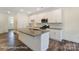 Kitchen with an island, white cabinets and stainless steel appliances at 6259 Tea Olive Dr # 178, Harrisburg, NC 28075