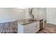 Open-concept kitchen with granite island, stainless steel appliances, and hardwood floors at 6259 Tea Olive Dr # 178, Harrisburg, NC 28075
