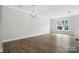 Bright living room featuring hardwood floors, a modern chandelier, and plenty of natural light at 6259 Tea Olive Dr # 178, Harrisburg, NC 28075