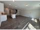 Spacious open-concept floorplan with an island, staircase, and lots of natural light at 6259 Tea Olive Dr # 178, Harrisburg, NC 28075