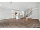 Open-concept living area with a modern kitchen, chandelier, and hardwood flooring at 6259 Tea Olive Dr # 178, Harrisburg, NC 28075